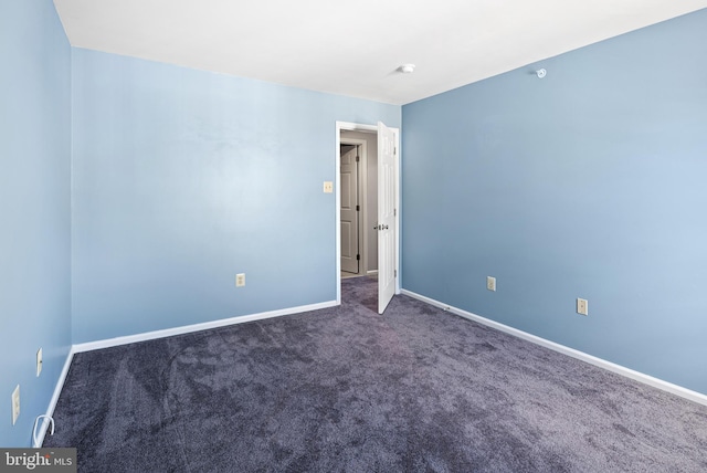 carpeted spare room with baseboards