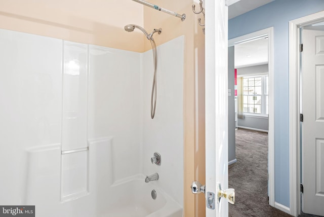 full bathroom featuring bathing tub / shower combination and baseboards