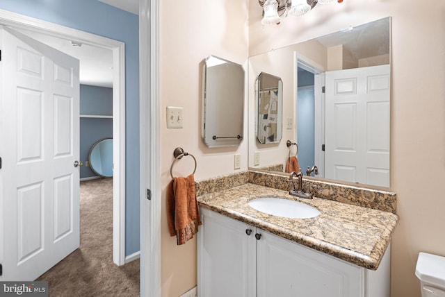 half bathroom featuring toilet and vanity