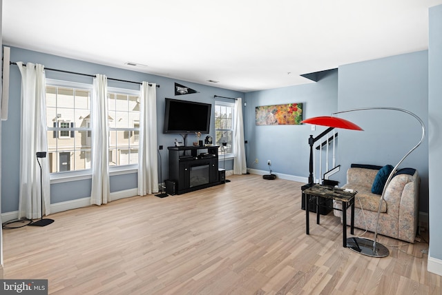 sitting room featuring visible vents, baseboards, and wood finished floors