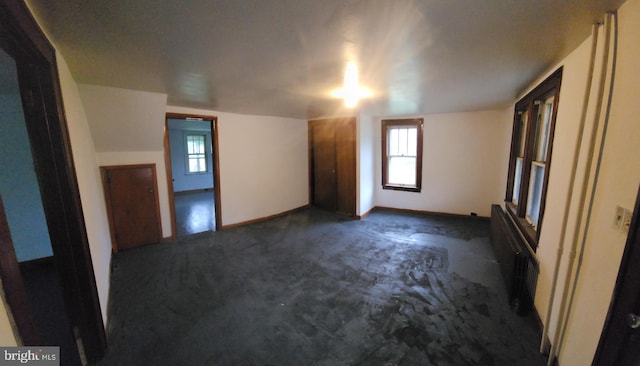 15941 Foundry Row NW, Mount Savage, MD 21545 - unfurnished room featuring dark colored carpet, radiator, and healthy amount of natural light