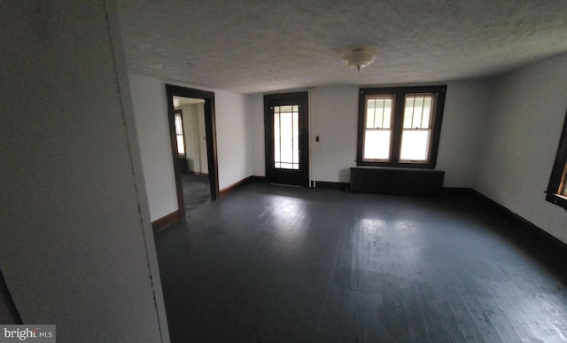 15941 Foundry Row NW, Mount Savage, MD 21545 - empty room featuring radiator, dark wood-style flooring, and a textured ceiling