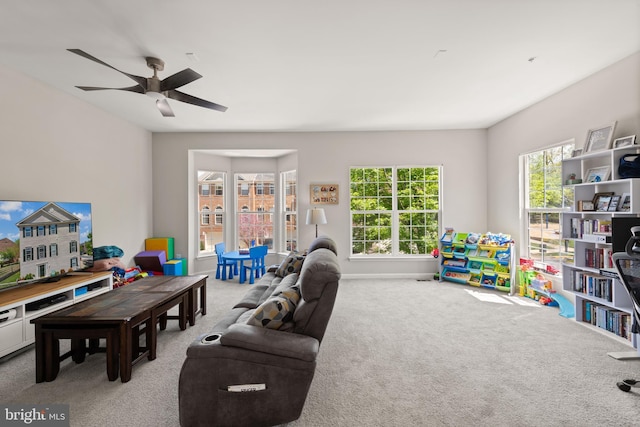 playroom with baseboards, plenty of natural light, a ceiling fan, and carpet flooring