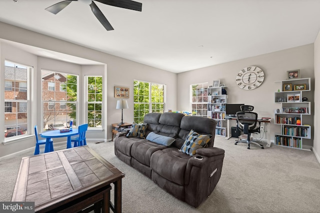 living room with carpet flooring, a ceiling fan, and baseboards