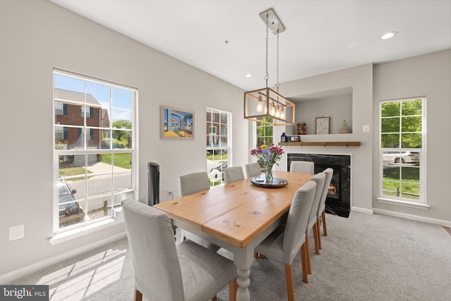 carpeted dining area with a healthy amount of sunlight, baseboards, recessed lighting, and a notable chandelier