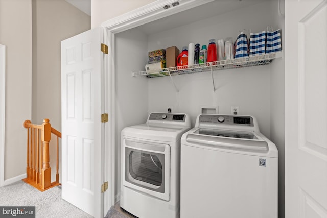 laundry area featuring independent washer and dryer, laundry area, light carpet, and baseboards