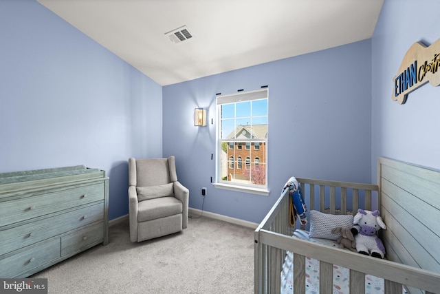carpeted bedroom featuring baseboards and visible vents