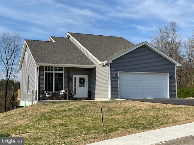 view of front of property with a garage, aphalt driveway, a front lawn, and a shingled roof