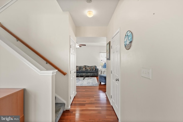 hallway featuring stairway and wood finished floors