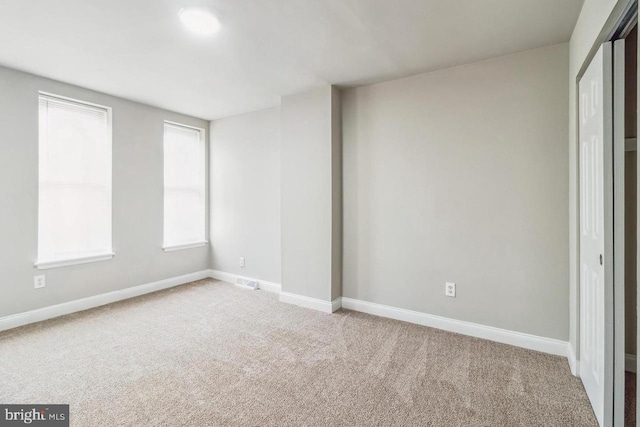 unfurnished bedroom featuring baseboards and carpet