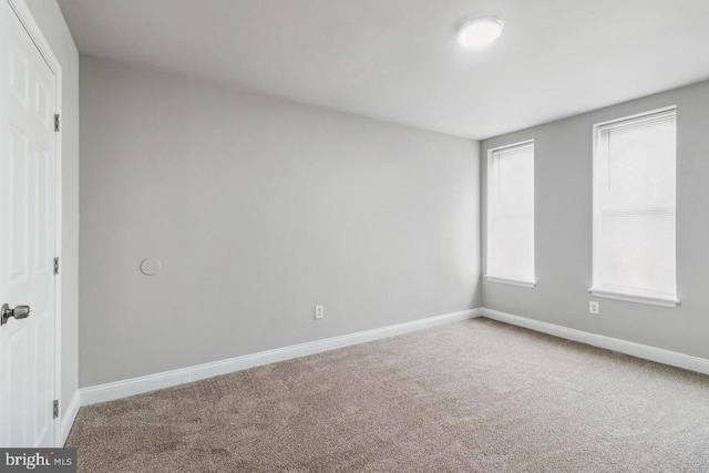 unfurnished bedroom with baseboards and carpet flooring