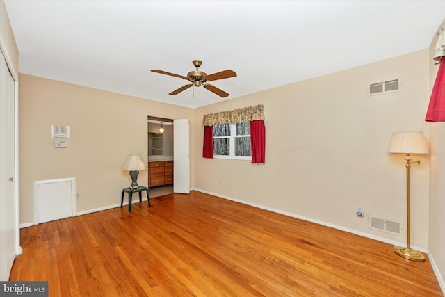 unfurnished bedroom featuring baseboards, visible vents, and light wood finished floors