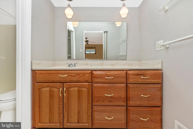 bathroom featuring visible vents, toilet, vanity, and a ceiling fan