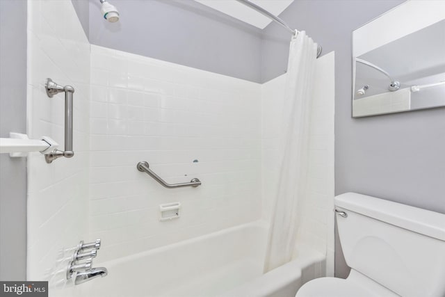 bathroom with toilet and shower / bath combo with shower curtain