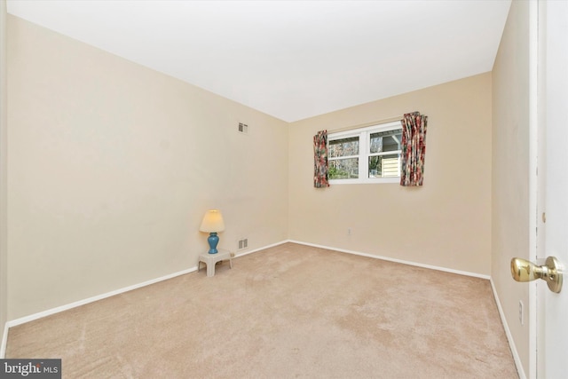 spare room featuring visible vents, baseboards, and carpet floors