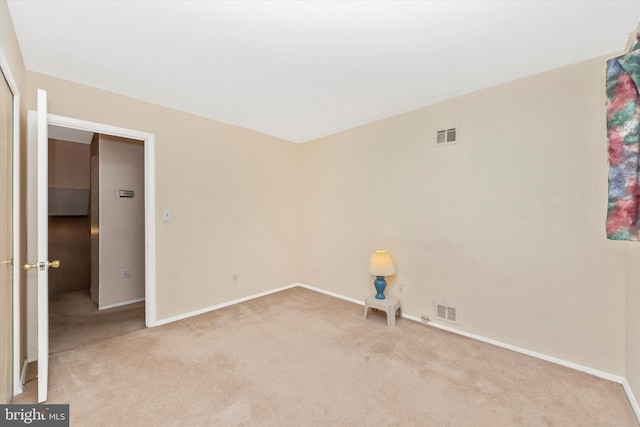 empty room with visible vents, carpet flooring, and baseboards