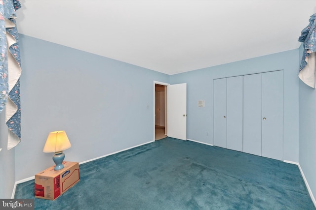 unfurnished bedroom with a closet, baseboards, and carpet floors