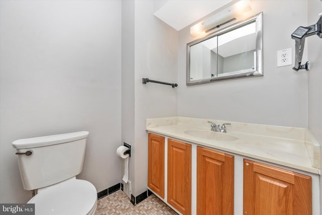 bathroom featuring toilet and vanity