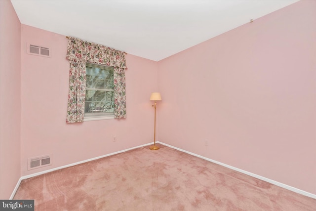 empty room with visible vents, baseboards, and carpet flooring