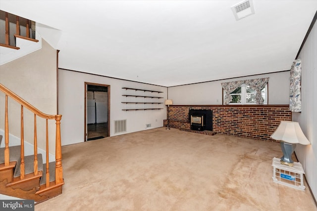 living area featuring visible vents, stairs, a wood stove, and carpet floors