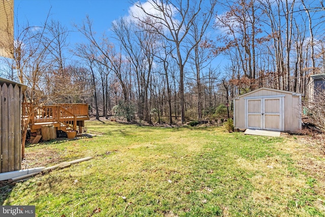 view of yard with a deck, a storage shed, and an outdoor structure