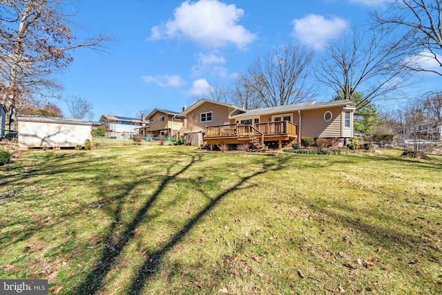 back of property featuring a wooden deck and a yard