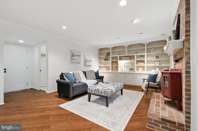 11807 Bare Sky Ln, Columbia, MD 21044 - living room with a fireplace, built in shelves, recessed lighting, baseboards, and wood finished floors