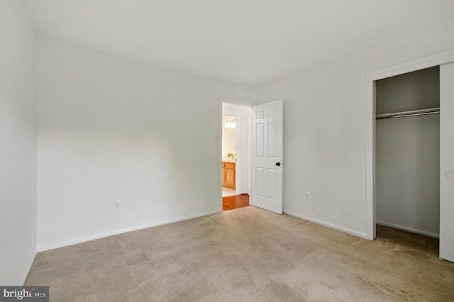 11807 Bare Sky Ln, Columbia, MD 21044 - unfurnished bedroom featuring a closet, baseboards, and light carpet