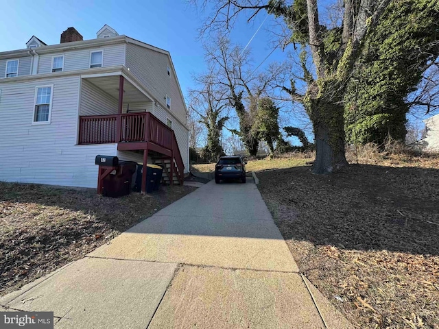 view of side of property with concrete driveway