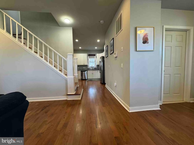 entrance foyer featuring visible vents, baseboards, stairs, recessed lighting, and dark wood-style flooring