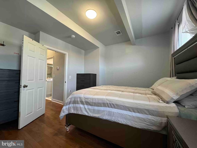 bedroom featuring visible vents, beamed ceiling, and dark wood-style flooring