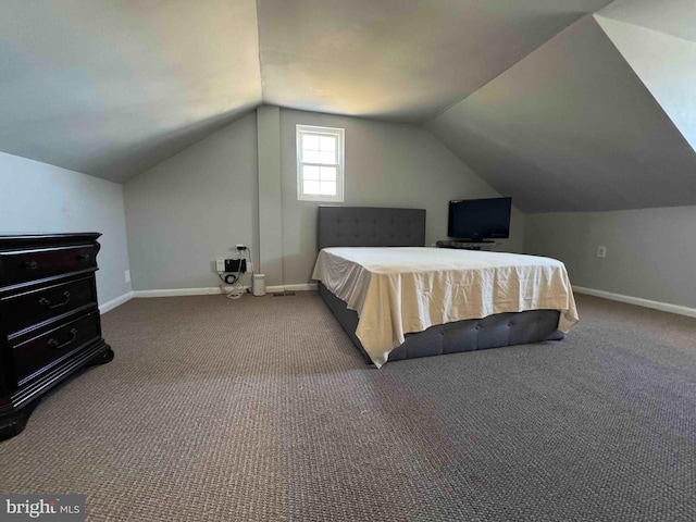 bedroom with vaulted ceiling, carpet flooring, and baseboards