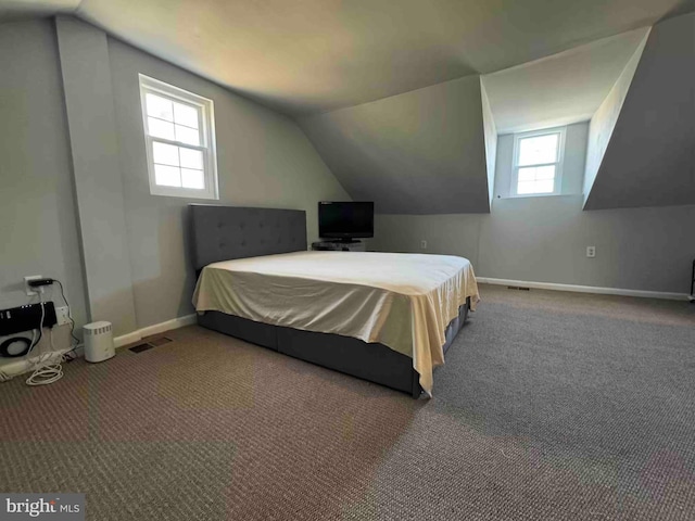 bedroom with carpet flooring, baseboards, and vaulted ceiling