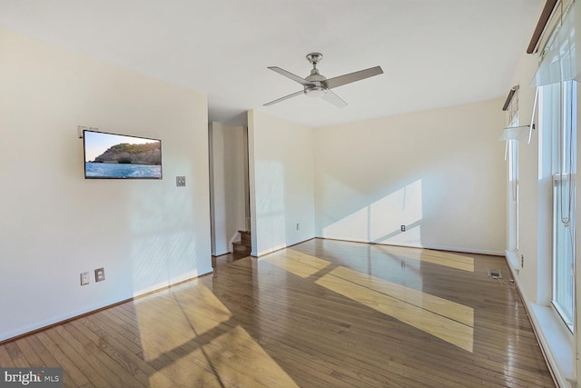 unfurnished room with visible vents, baseboards, ceiling fan, and wood-type flooring