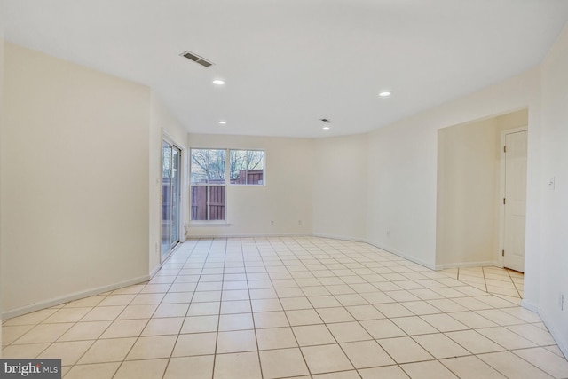 empty room with light tile patterned flooring, recessed lighting, visible vents, and baseboards