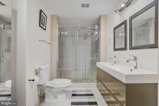 bathroom with visible vents, a stall shower, toilet, and vanity