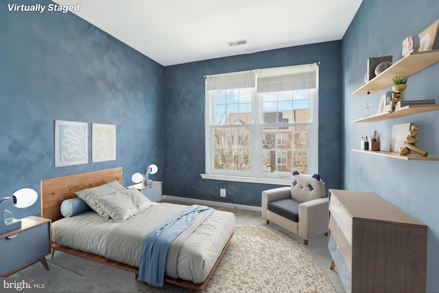 carpeted bedroom featuring visible vents and baseboards