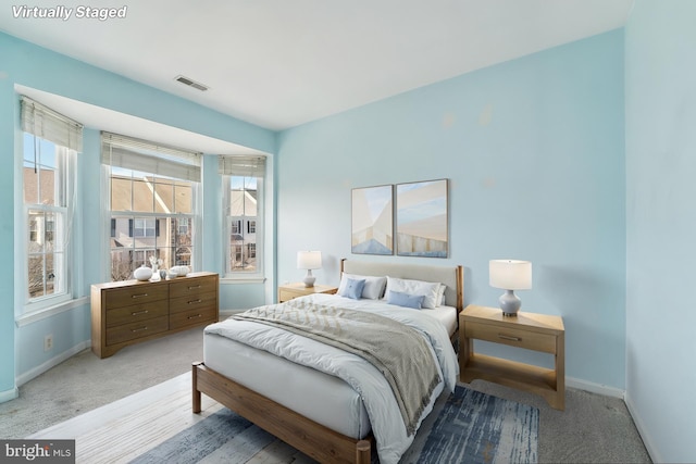 bedroom with baseboards and visible vents