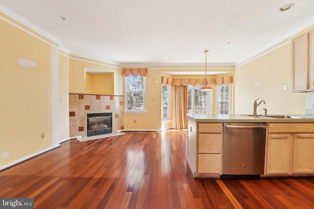 kitchen with a tiled fireplace, dark wood-style flooring, a sink, dishwasher, and open floor plan