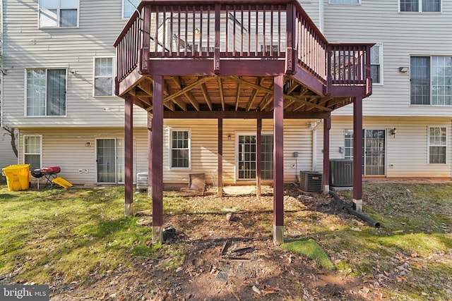 back of house with central AC unit and a deck