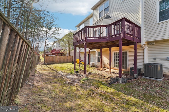 exterior space with cooling unit, a deck, and fence