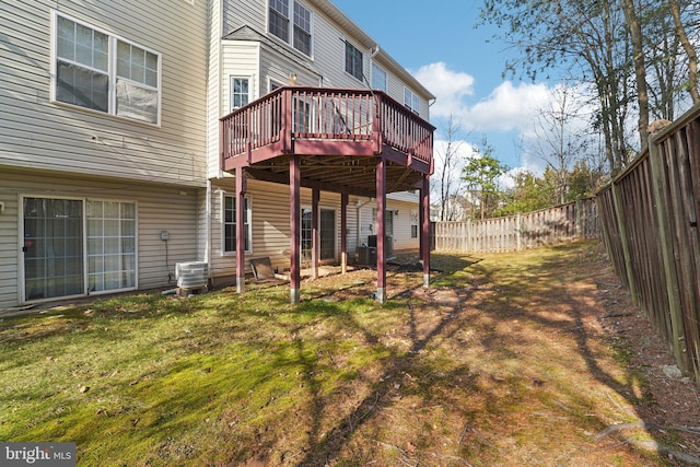 back of house with a deck, a lawn, central AC unit, and a fenced backyard