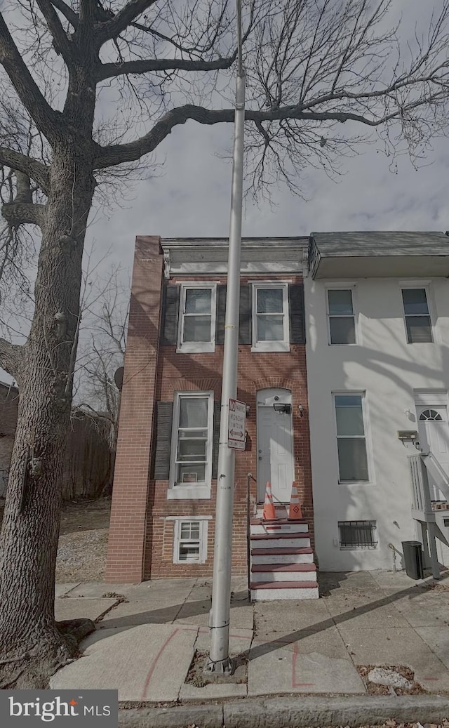 view of property featuring brick siding