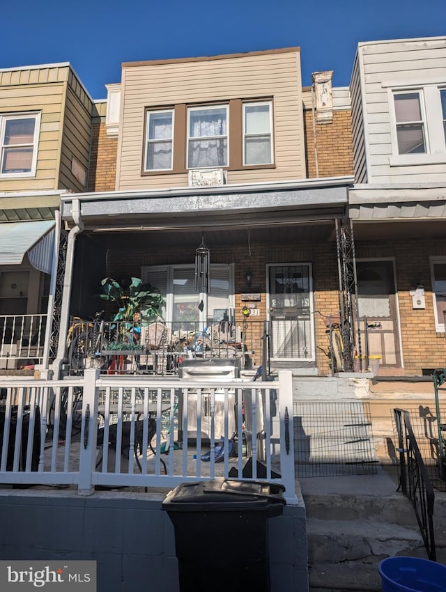 view of front of property with a porch and brick siding