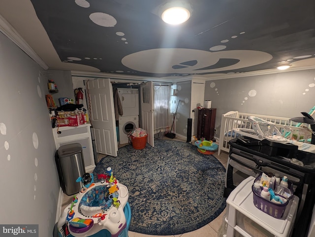 interior space featuring crown molding and stacked washer and dryer