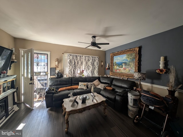 living area with a ceiling fan and wood finished floors