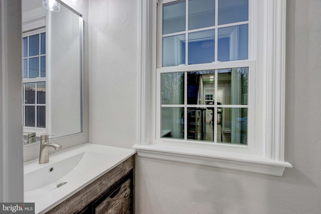 bathroom featuring vanity and a textured wall