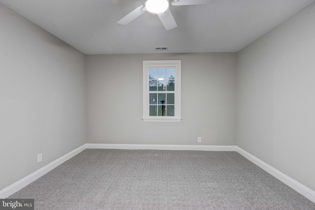 unfurnished room featuring visible vents, a ceiling fan, baseboards, and carpet floors