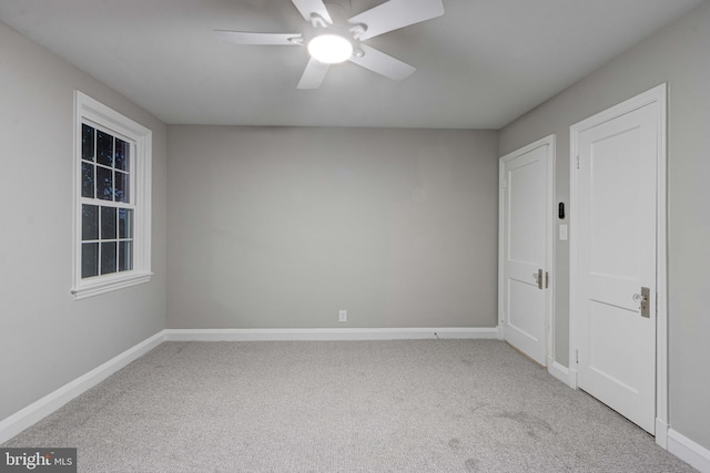 spare room featuring baseboards, carpet, and a ceiling fan