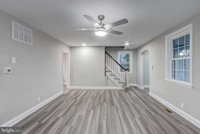 interior space featuring visible vents, stairway, baseboards, and wood finished floors